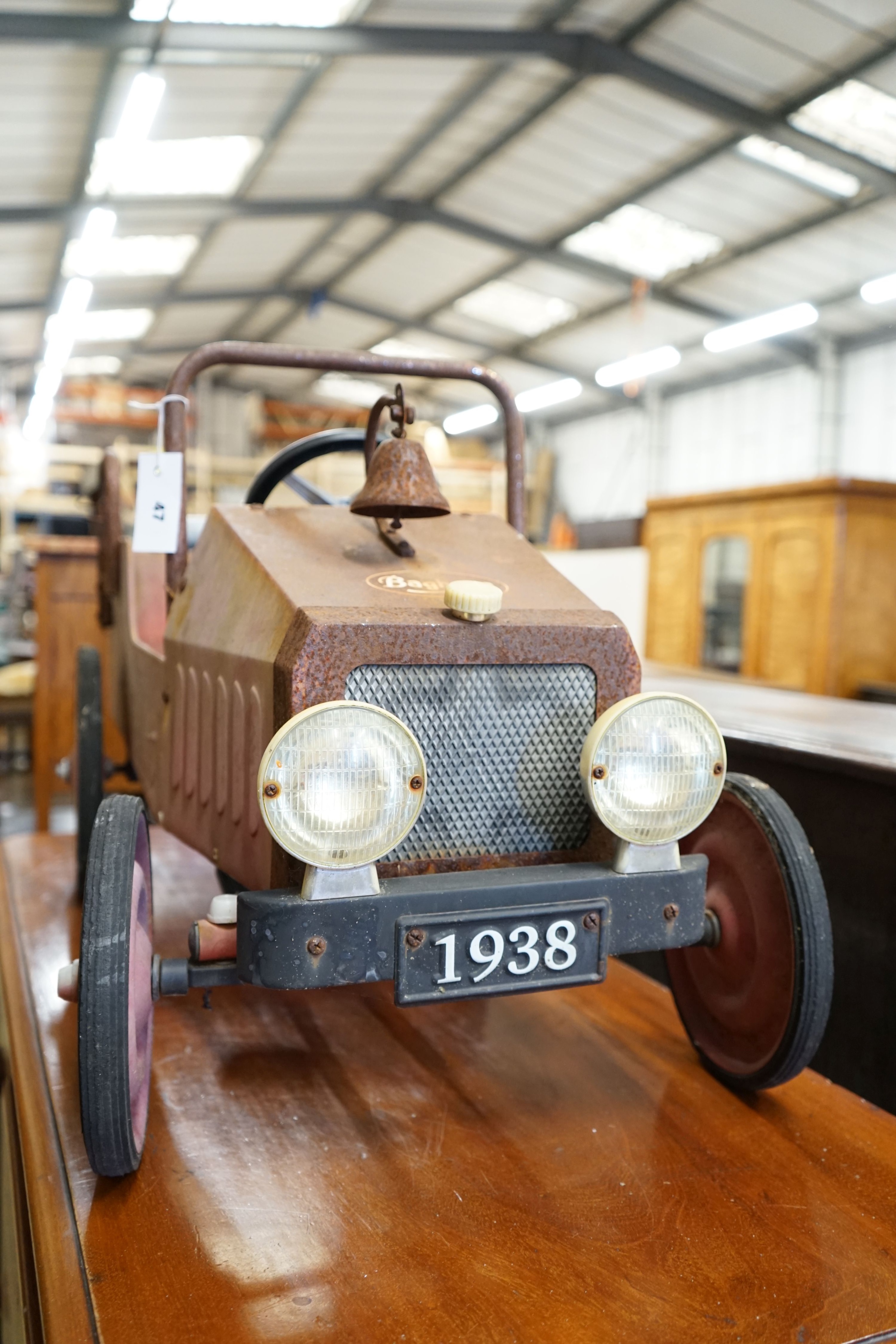 A child's tin plate pedal ride on toy fire engine, length 95cm